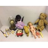 Qty of dolls & teddies incl. a black doll; flatware & a clock