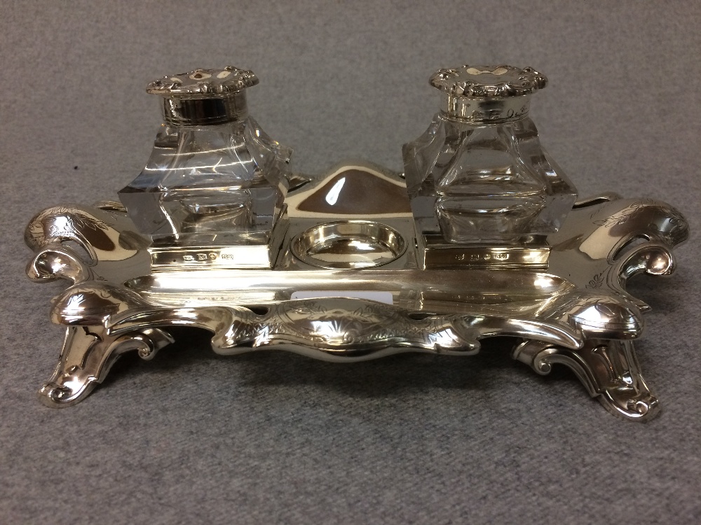 Hallmarked silver desk ink stand of 2 glass bottles on Rococo base