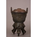 C17th Chinese tripod censer, Ding, cast with twin upright handles, decorated with a band of taotie