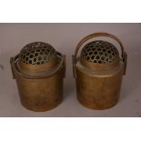 A pair of Chinese bronze cylindrical hand warmers and pierced covers, 22cm high. (2) Please check