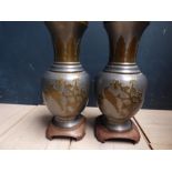 Pair Chinese tin and brass table lamps with floral and bird decoration on wooden stands Please check