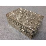 Good hallmarked silver oblong box with hinged lid, gilt interior and extravagantly embossed with