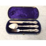 Child's hallmarked silver Christening set of knife, fork and spoon, the handles with repousse
