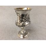 Victorian hallmarked silver campana shaped cup with a bacon cartouche and repousse foliage, the
