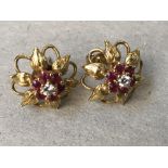 A pair of diamond and ruby, 18 carat gold, cluster ear studs, the seven stone cluster enclosed by