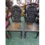 Pair of carved oak Victorian hall chairs