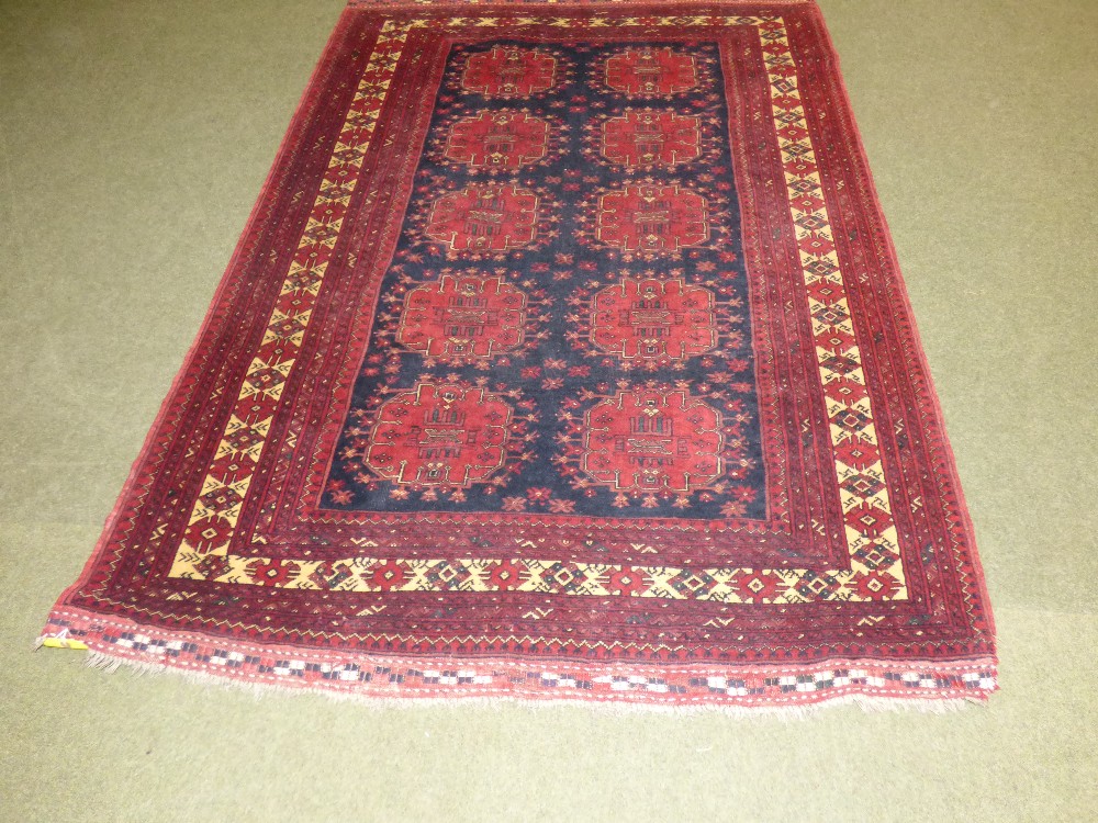 Persian oblong rug and blue central panel of 10 red loztenges with wide terracotta multi border