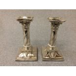 Pair of hallmarked silver square based candlesticks with swags & ram's head decoration, London 1895,