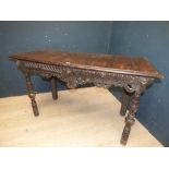 Georgian oak side table with 2 single drawers flanked by carved lion's masks on carved turned