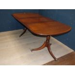 A George III design mahogany twin pedestal dining table with one extra leaf