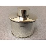 A late Victorian hallmarked silver tea caddy by 'Nathan & Haynes' Chester 1897 of oval outline