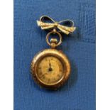 A fob watch, stamped '14K', with gilt metal cuvette, bar movement with cylinder escapement, 3.2cm