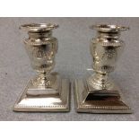 Pair of hallmarked silver square based urn shaped candlesticks, Sheffield 1897, 11.5cm H