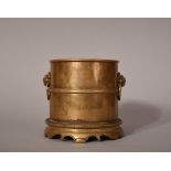 C18th Chinese bronze cylindrical censer, cast with two lion-head handles to each side, Xuande six-