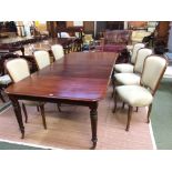 Victorian mahogany extending oblong dining table with 2 leaves on turned legs to brass castors.