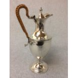 Hallmarked silver urn shaped hot water jug with cane handle, London, 22 ozt