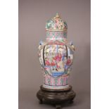 C19th Chinese famille rose lidded vase, painted with panels of figural scenes, 38.5cm high, wood