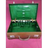 Silver fitted suitcase with jars, bottles & green leather interior