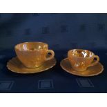 Qty of orange lusterware cups and saucers