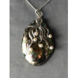 Unusual silver pendant necklace mounted to a abalone shell in the form of a squid