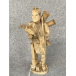 C19th carved ivory figure of a Chinese fisherman carrying a cormorant, character marks to base, 25.