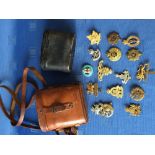Qty of various military badges & 2 pairs of binoculars