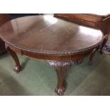 Carved mahogany oval extending dining table with cabriole legs and claw and ball feet & a set of 6