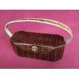 Dark brown crocodile handbag in oblong box shape by Premier America with purse
