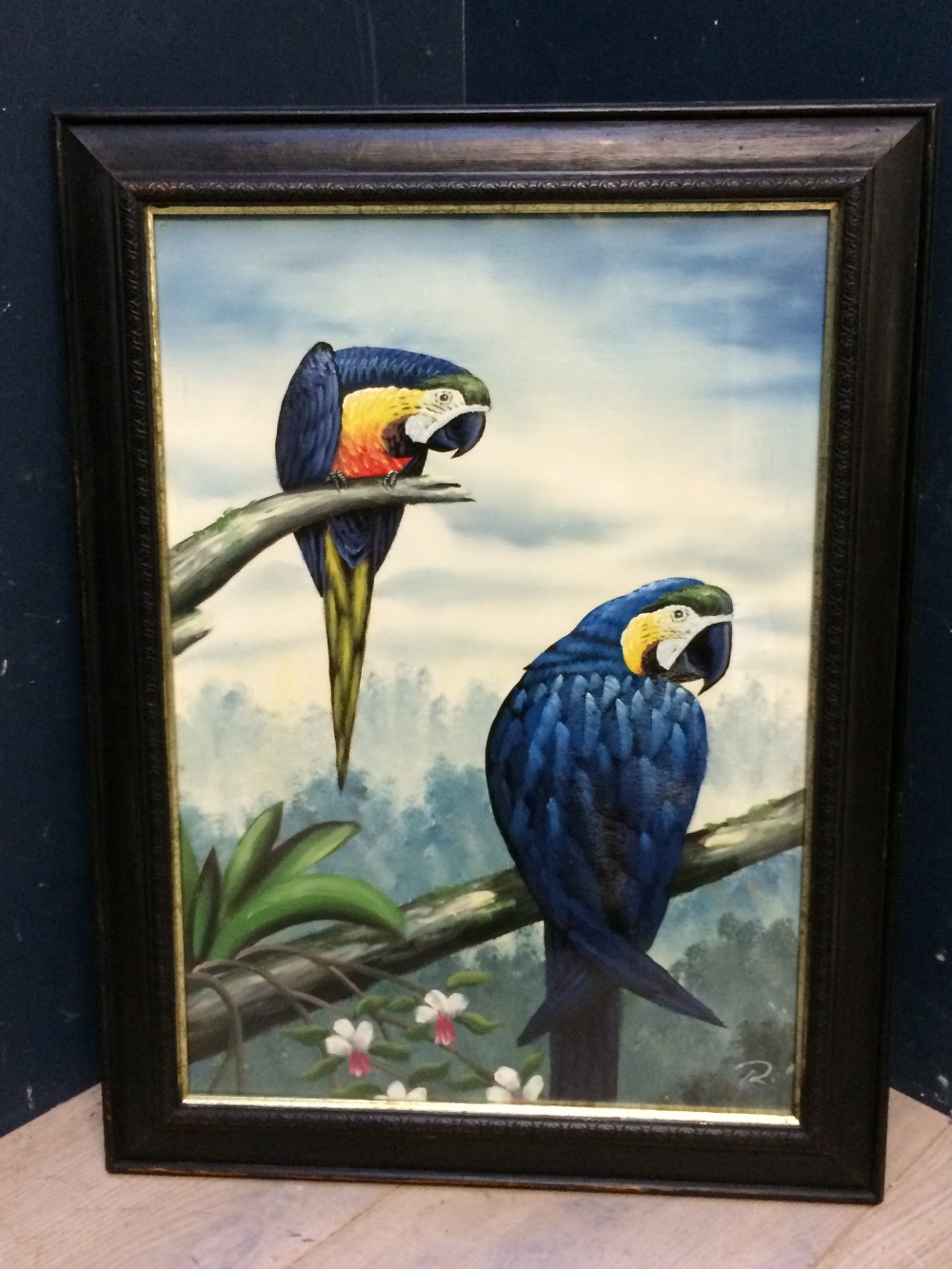 Oil painting, ornithological study of two parrots perched on branches, signed with monogram, in an