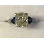 18 carat white gold and cushion cut diamond ring, of 2.5 carats, with heart shaped sapphire