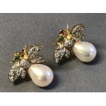An unusual pair of 18 carat yellow gold, diamond and emerald earrings with cultured pearl bodies