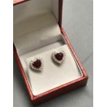 Pair of 18 carat white gold heart shaped ruby and diamond earrings