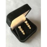 Pair of 14 carat yellow gold graduated diamond heart shape earrings