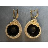Pair of silver gilt and onyx panther earrings with emerald eyes