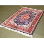 Blue ground fine weave Persian rug with terracotta ground border all over stylised floral and