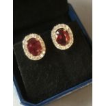 Pair of 18 carat yellow gold, ruby and diamond earrings, 6.3 carats total weight