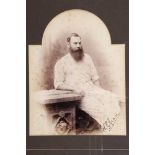 W.G. Grace. Original sepia studio photograph of Grace, three quarter length seated wearing cricket