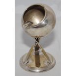 Silver metal EPNS ball ashtray mounted on three crossed cricket bats on circular metal base.