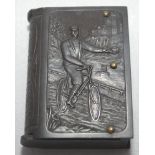 Cycling vesta case. Unusual Victorian bakelite brown vesta case, modelled as a book, depicting a