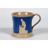 Staffordshire blue ground waisted cricket mug with strap handle and beaded rim. With three relief