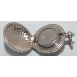 Golf ball shaped sovereign case. Silver metal case with button action to top. Metal ring suspension.