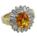 Approx. 3.89 Carat Oval Cut Orange Sapphire, 1.50 Carat Round Brilliant and Baguette Cut Diamond and