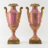 Pair of Antique Bronze Mounted Sevres Porcelain Bolted Urns. Pink ground with gilt decoration.