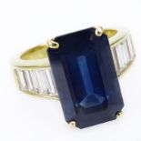 Approx. 9.32 Carat Emerald Cut Sapphire, 2.05 Carat Baguette Cut Diamond and 18 Karat Yellow Gold