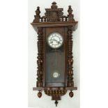 Early 20th Century Vienna Carved Wood Regulator Clock. Porcelain dial with roman numerals display