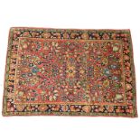 Antique Persian Sarouk Rug. Sprays of flowers on borders and colorful flowers en center. Cloth label