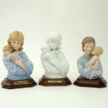 Three (3) Edna Hibel Porcelain Sculptures "Mother And Child" On Wood Bases. All pieces signed and in