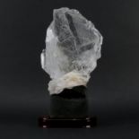 Rock Quartz Lapidary Specimen on Wooden Stand. Clear to light shades of brown, with various