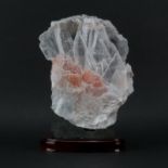Rock Quartz Lapidary Specimen on Wooden Stand. Clear to rose color shades and various structures.