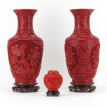 Three (3) Chinese Cinnabar Style Tableware on Wooden Stands. Includes: two matching vases and a